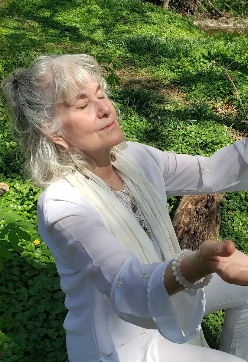 andrea brachfeld ajarona 1 Ajarona energy healer sitting in nature with eyes closed and hands open in a receiving pose Baltimore Maryland